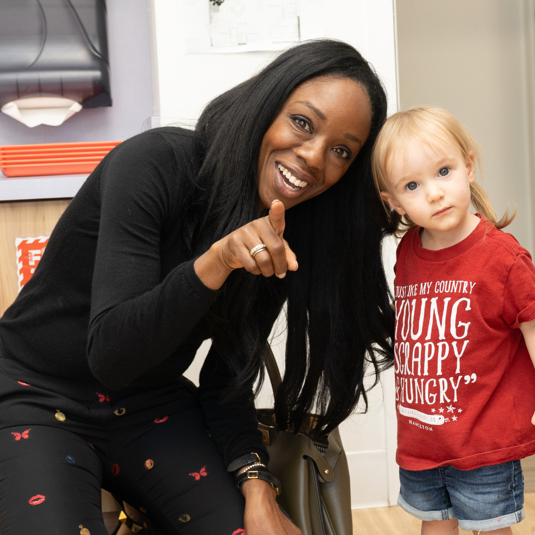 Dr. Nadine Burke Harris with child at Opportunity Early Childhood Center