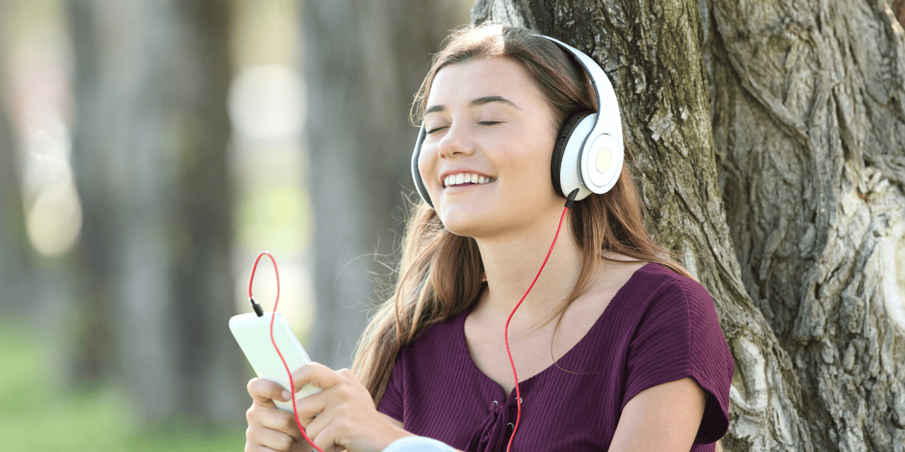A teen relaxing with their phone
